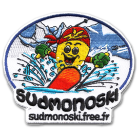 Ecusson de l'associations portive sud monoski. L'écusson ovale représente un petit personnage jaune souriant sur un monoski orange faisant voler des gerbes de neige autour de lui. Derrière, un paysage de montagne est brodé. Au bas de l'écusson, le texte sudmonoski, sudmonoski.free.fr est écrit en noir sur fond blanc.