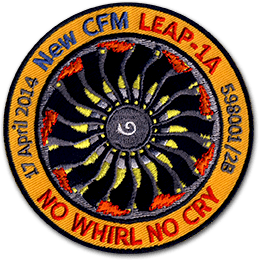 Ecusson de Safran pour le test du moteur LEAP 1A. Il représente un réacteur noir et jaune sur fond rouge. la bordure de l'écusson est orange, et on peut y lire le texte 17 april 2014 New CFM No whirl no cry.
